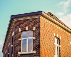 A low angle shot of an apartment building under the sunlight at daytime