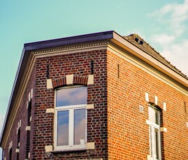 A low angle shot of an apartment building under the sunlight at daytime